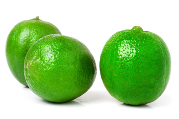 three lime isolated on white background close up