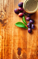 Fresh plum jam on a wooden background