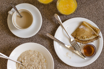 Oatmeal pancakes fresh orange juice coffee and scrambled eggs for breakfast  