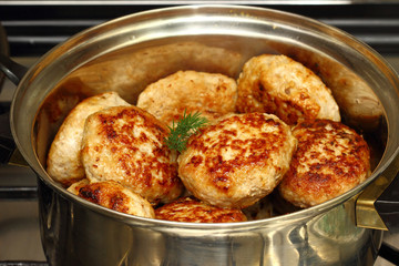 Cutlets fried in a pan .