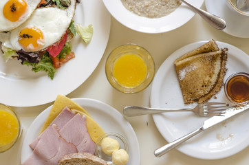 Oatmeal pancakes fresh orange juice coffee and scrambled eggs for breakfast  