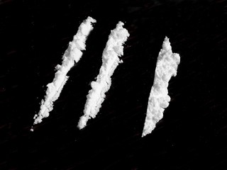 Cocaine drug powder on black background