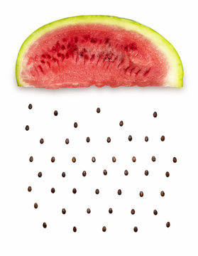 Watermelon rain / Creative concept photo of a watermelon slice with seeds falling down on white background.