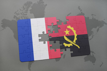 puzzle with the national flag of france and angola on a world map background.