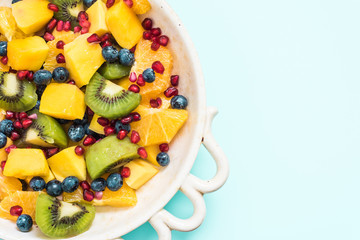 exotic fresh fruit salad in rustic bowl