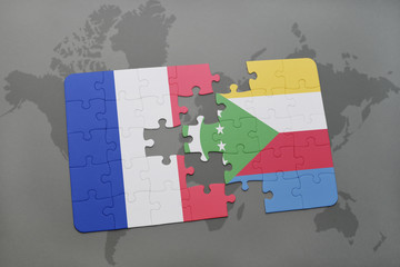 puzzle with the national flag of france and comoros on a world map background.