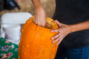 Halloween, decoration concept - close up of woman with pumpkin