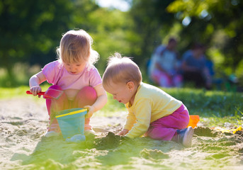 Two children playing in sandbox