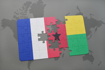 puzzle with the national flag of france and guinea bissau on a world map background.