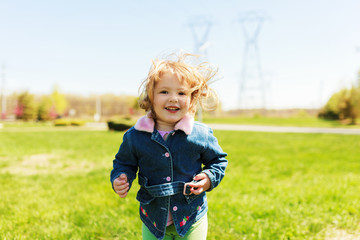 pretty little girl playing outdoors in spring