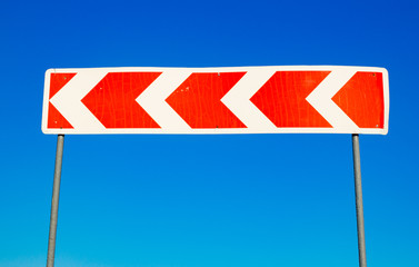Red traffic sign against a blue sky