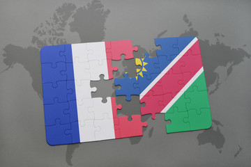 puzzle with the national flag of france and namibia on a world map background.