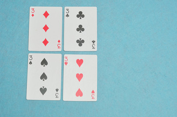 The different suits of a the number 3 card in a deck of cards di