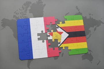 puzzle with the national flag of france and zimbabwe on a world map background.