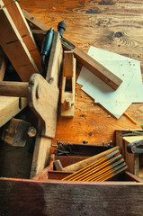 Equipment carpenter on a wooden desk with plans