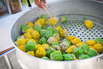 Chinese steamed pork dumpling in green and yellow color. Easy snack street food in Thailand. 