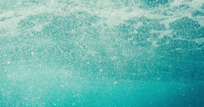 Water texture, underwater view of bubbles and waves in the ocean