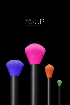 Makeup concept. Colorful Make up brushes over black background