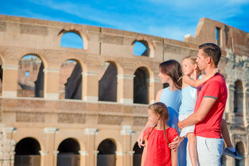 Happy family enjoy their vacation on Colosseum background. Italian european vacation together in Rome