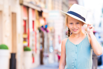 Adorable happy little girl outdoors in european city. Portrait of caucasian kid enjoy summer vacation in Rome