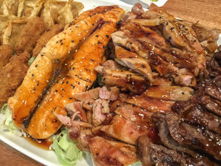 Appetizer with salmon, beef and pork brisket and two sides