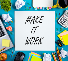 Make it work. Office table desk with supplies, note pad, cup, pen, pc, crumpled paper, flower on...
