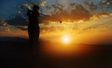  Silhouette women of golfer  at beautiful sunrise
