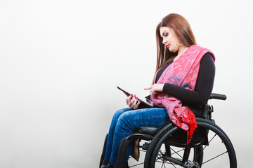 Young disabled lady with tablet.
