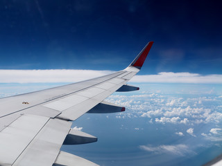 Wing of the plane on blue sky