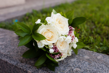 Bridal bouquet of beautiful roses for a wedding on wooden background