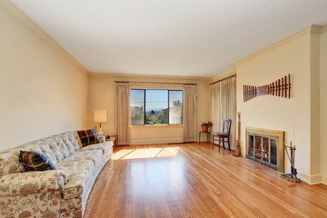 Spacious living room interior with large sofa and fireplace