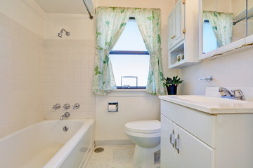 Fototapeta na wymiar Old style bathroom interior with white cabinets