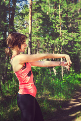 Young fitness woman runner stretching before run. Runner athlete
