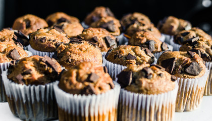 Close up photo of chocolate chip muffins at a street food market. Selective focus