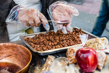 Cooking of garrapinada caramelized peanuts at a weekend fair in San Telmo neighborhood, Buenos Aires