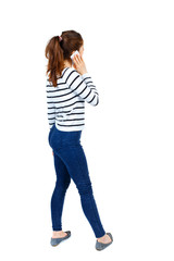 back view of a woman talking on the phone.  backside view of person.  Rear view people collection. Isolated over white background. Girl in a striped sweater and is talking on the phone.
