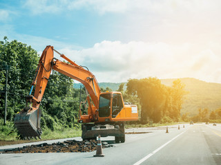 Excavator working at road construction site