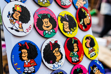 Colorful fridge magnets with Mafalda comics cartoon character at a weekend fair in San Telmo neighborhood, Buenos Aires. 