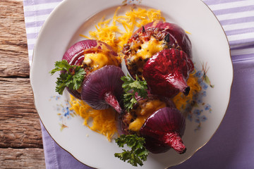 Tasty baked red onion with meat and cheddar closeup. Horizontal top view
