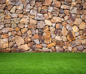 green grass with brown stone background