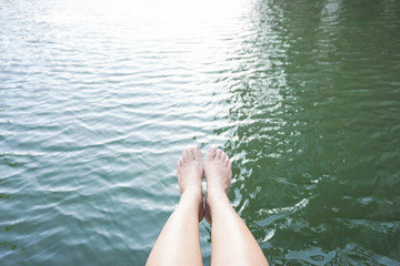 Fototapeta premium concept of relaxation by putting legs into water