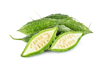 whole and half cut fresh bitter gourd on white background