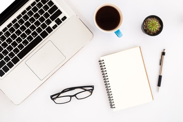 White office desk table with laptop,pencil,blank screen smartphone,leather notebook,chart or graph and cup of coffee. Business desk table concept.