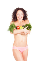 Beautiful model holding a vegetables and salad. She shows the abdomen and waist. The concept of a healthy diet and lifestyle. Weight Loss.