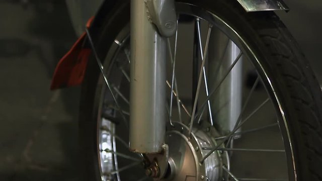 Electric bicycle details closeup, front wheel, shock absorbers on steerer tube