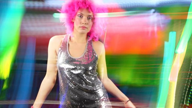 woman dances with pink crazy hairstyle