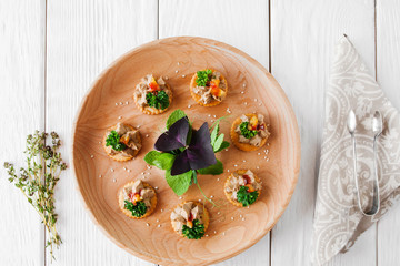 Foie gras plate on white wooden background, flat lay. Delicious french delicatessen on crackers, served on catering board. Wedding, celebration, luxury expensive food © golubovy