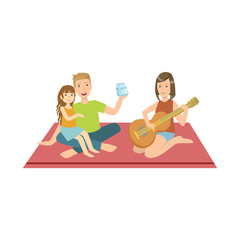 Family On Picnic With Mom Playing Guitar