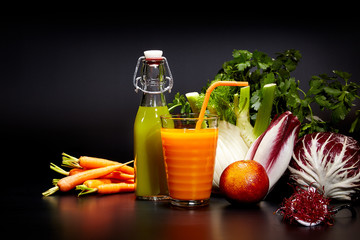 Glasses with fresh vegetable juices isolated on black. Detox die