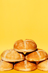 Fresh buns on yellow background